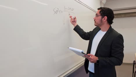 man visually solving a problem on a board