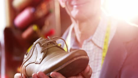 shoemaker examining a shoe