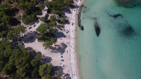 Revealing-clip-over-an-exotic-beach-in-Vourvourou,-Haklidikin-in-northern-Greece-on-a-clear-summer-day