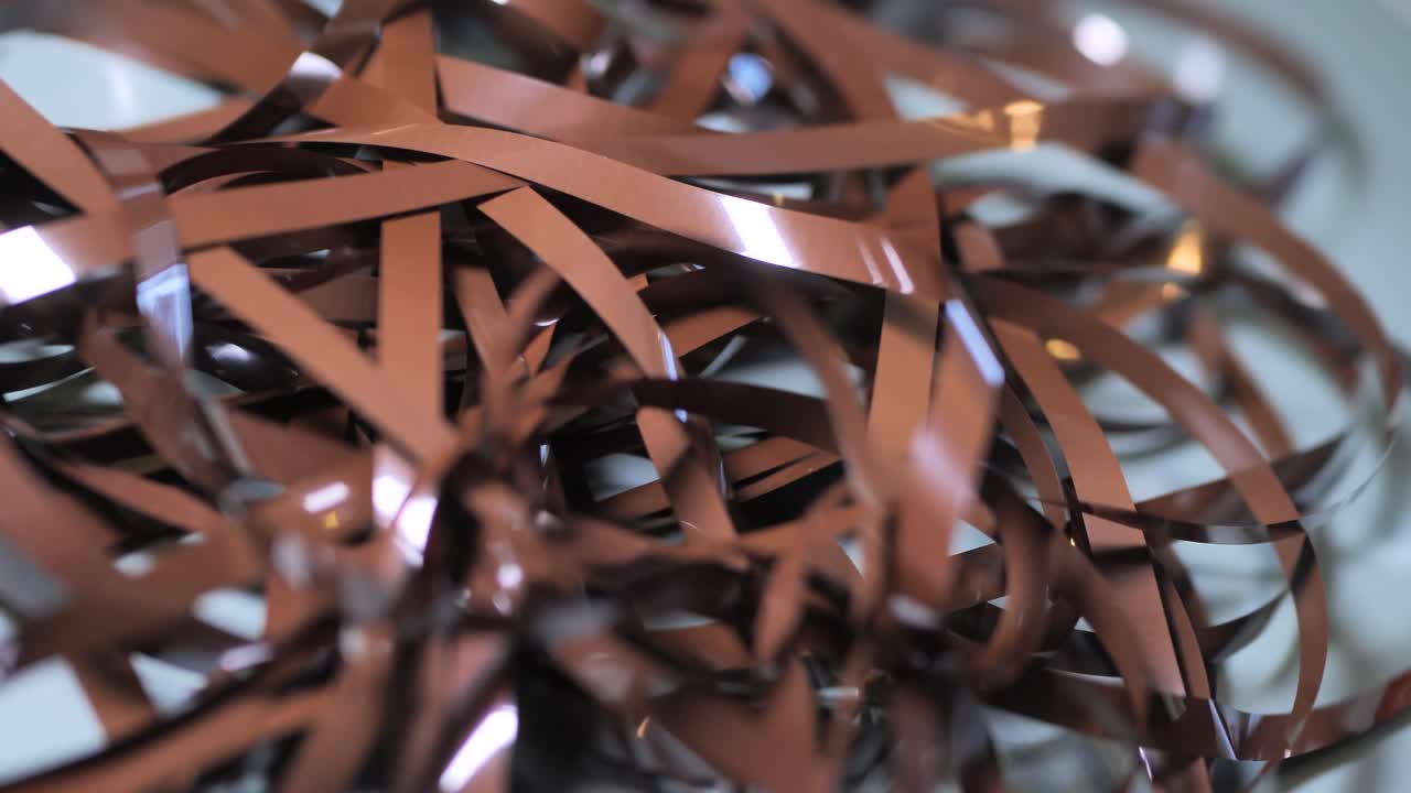 Tape Unreel. Pulling the tape out. Destroying cassette tape media. Zoom in