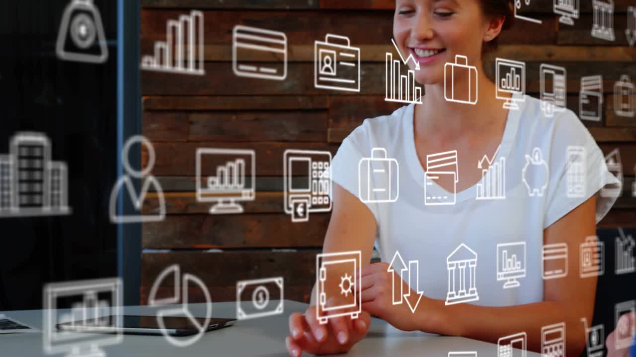 Employee reviewing data on laptop with colleague leaning, sparking finance icons highlighting data