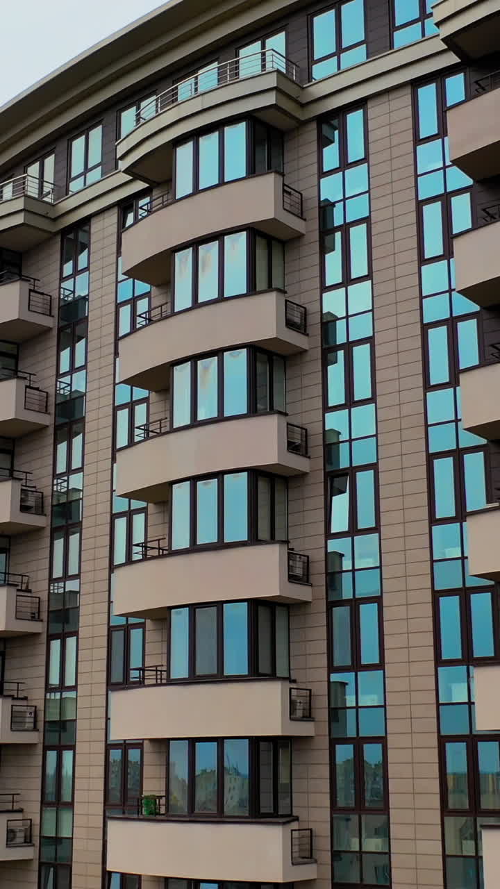 Typical apartment building in urban area. Aerial view of facade of modern high rise multi storey apartment building. Vertical video