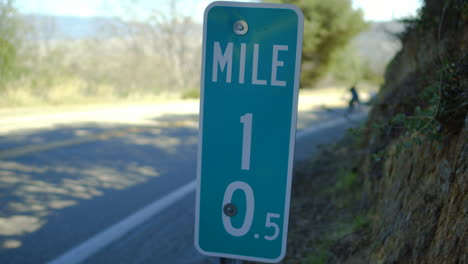 3-men-going-very-fast-while-downhill-longboarding-down-a-mountain-road-on-skateboards-in-Glendora,-California