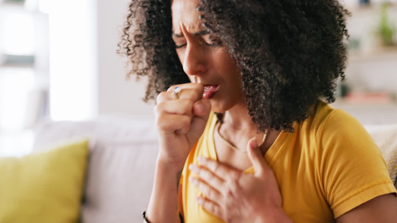 Black woman, cough and sick in house on couch