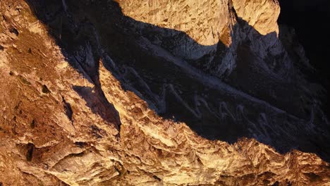 Droneshot-tilting-up-towards-the-summit-at-sunrise