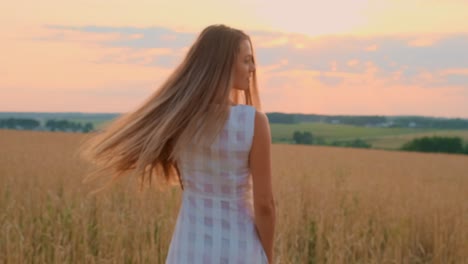 woman laughing in a wheat field at sunset