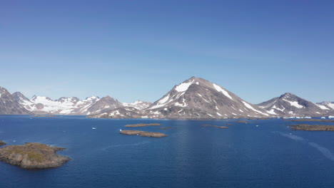 small islands and cold blue ocean off the coast of greenland