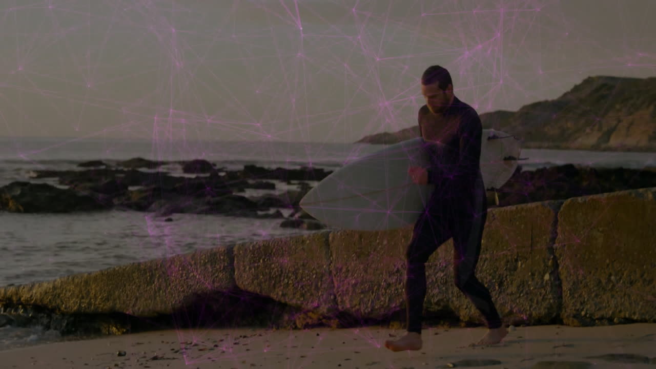 Surfer stepping onto breakwater carrying surfboard on shoreline, showing purple technology overlay