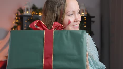 Heartwarming-Christmas-Moment:-Brunette-Woman's-Joyful-Surprise-Gets-Present-at-Home