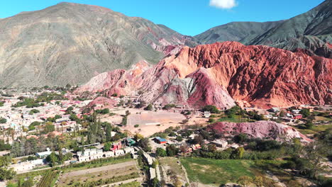 Drone-circling-around-Purmamarca,-showcasing-its-Seven-Colors-Mountain-and-picturesque-village