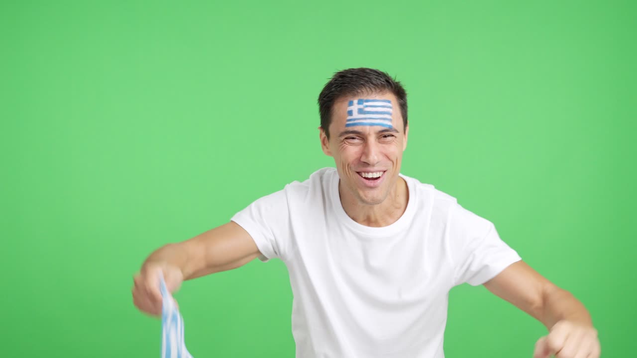 Man cheering for Greece screaming and waving a national flag