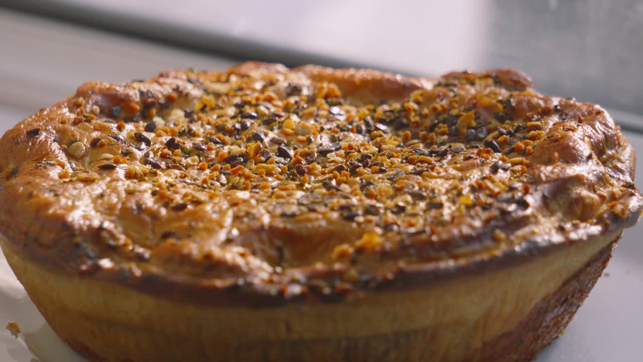 Whole View of Delicious Gourmet Chicken and Mushroom Pie with Seeds on Top with Rustic Texture of Pastry Ready to Portion and Serve for Dinner