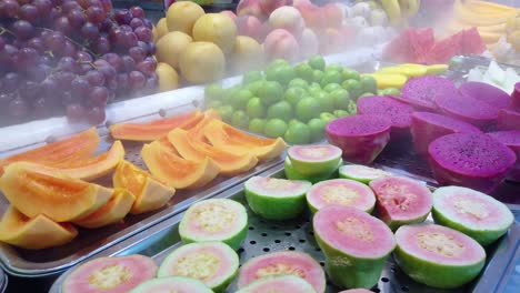 Chilled-bowls-with-freshly-cut-delicious-juicy-fruits-for-sale-on-market-in-China