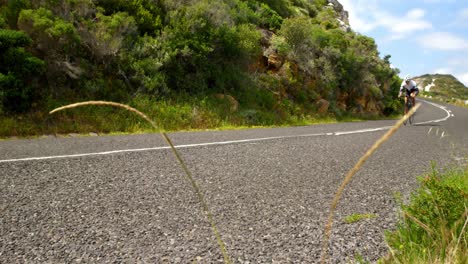 Female-cyclist-cycling-on-a-countryside-road-4k