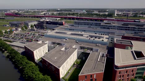 Aerial-ascend-revealing-Dutch-Antonius-medical-care-facility-hospital-in-city-of-Utrecht-in-contemporary-newly-build-Leidsche-Rijn-neighbourhood