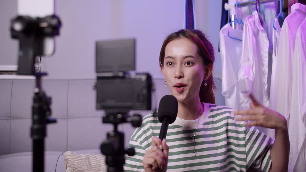 A young host engages audiences through live streaming in a cozy room showcasing creative content.