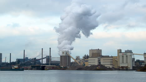 Enormous-amount-of-smoke-rising-from-industrial-building---wide