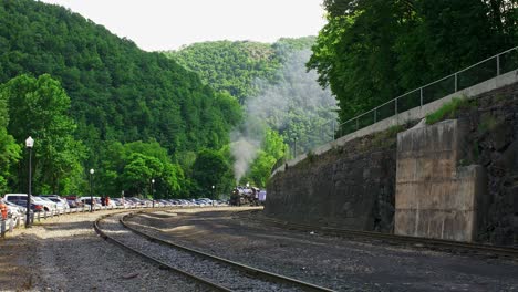 steam train chugging through a mountain valley