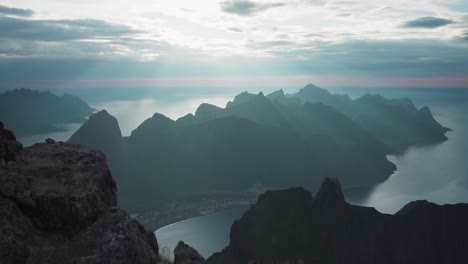 sunrays over the grytetippen peak and fjord in fjordgard, norway