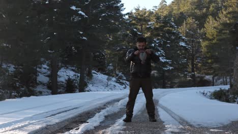 man standing in snowy road