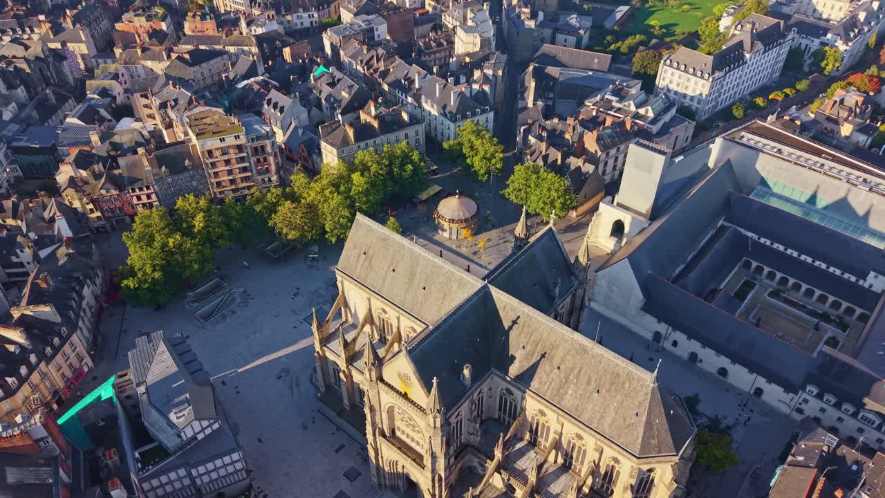 Downward drone fly at Place Saint-Anne and Basilica of Saint-Aubin in Our Lady aka Basilique Saint-Aubin en Notre-Dame-de-Bonne-Nouvelle with Jacobin Convent behind, Rennes, Ille-et-Vilaine, France