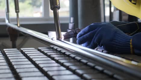 man wearing mask welding in a workshop. metal workers use manual labor. skilled welder. welder is welding the stainless steel pipes in the factory. welder industrial part in factory.