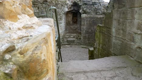 Ancient-Basingwerk-abbey-abandoned-historical-landmark-building-stone-walls-staircase-dolly-right