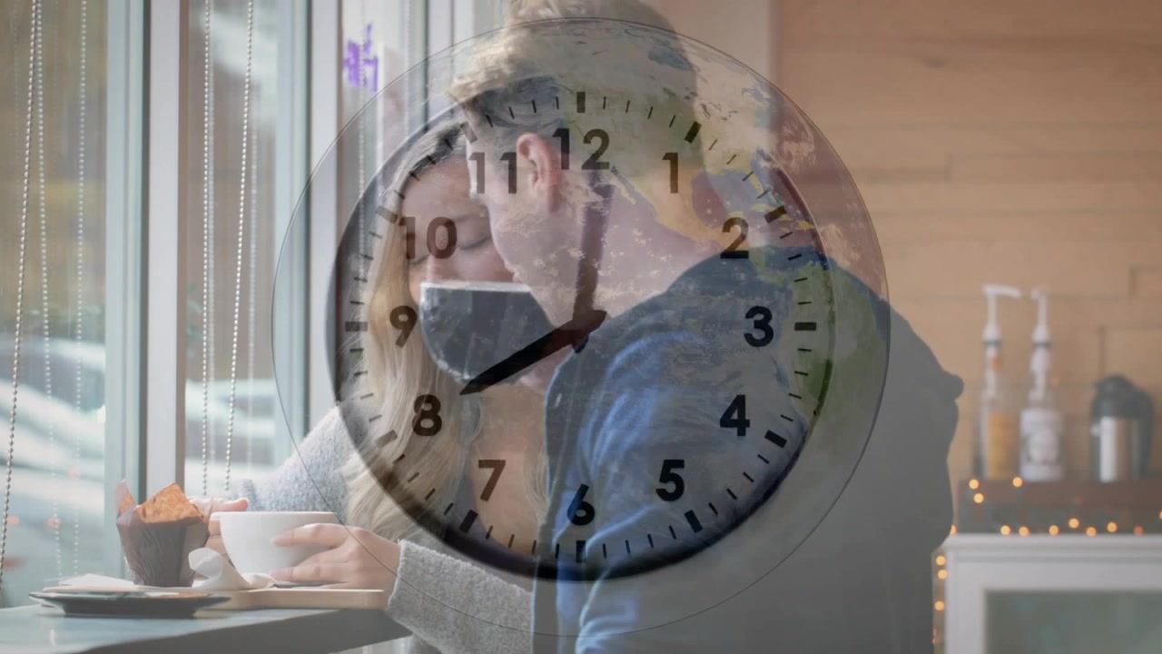 Hombre inclinándose y mujer bebiendo de una taza en el mostrador de una cafetería, con un reloj superpuesto girando, compartiendo una conversación.