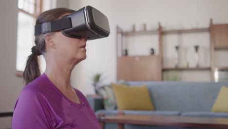 woman using vr headset while performing yoga at home