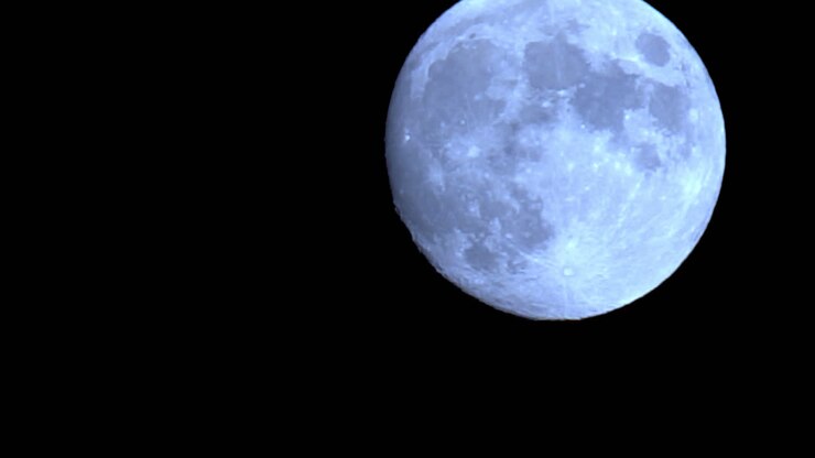 Time-lapse astronômico de uma lua cheia cruzando o céu noturno.