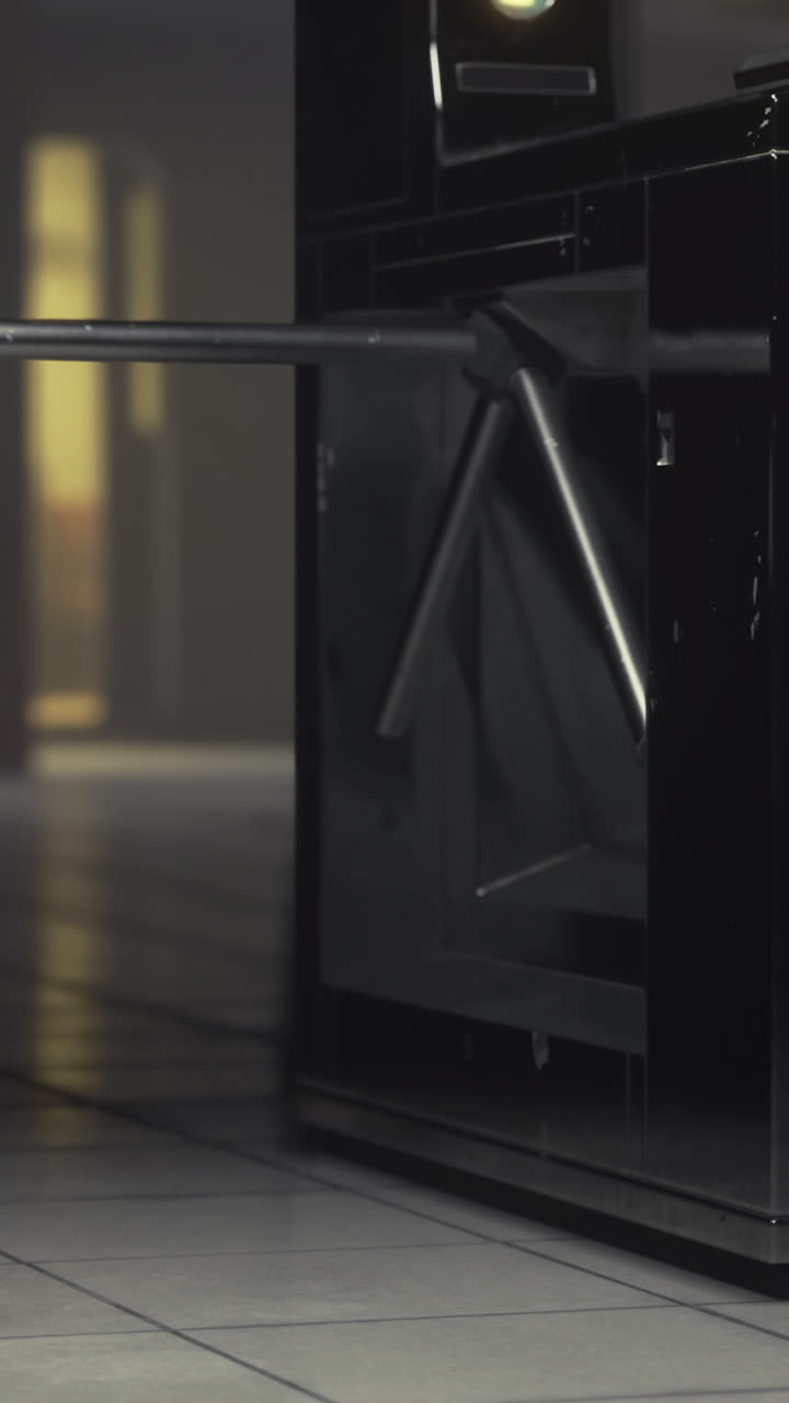 Turnstiles guide entry into a modern transit station at night