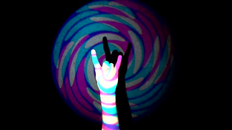 the human hand doing horns sign with his fingers on background of colorful tunnel flythrough loop