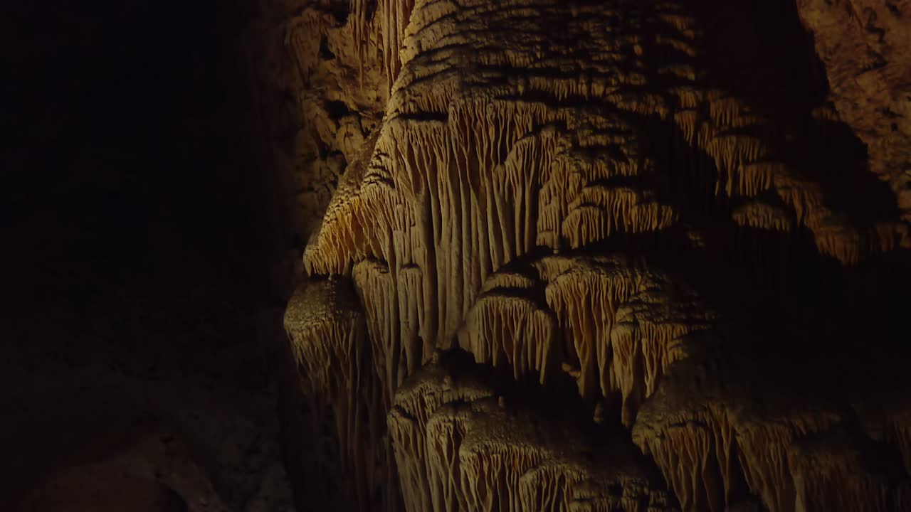 Stalactite Formations Hanging from the Cave Ceiling in a Shadowed Carlsbad Caverns Area