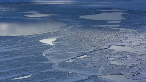 aerial view of frozen arctic landscape with intricate ice patterns