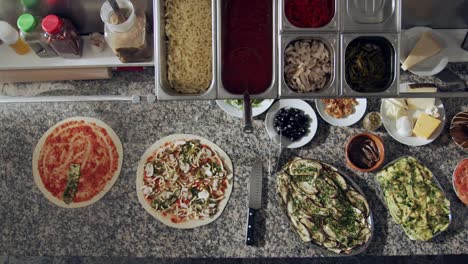 preparing vegetarian pizza in restaurant kitchen