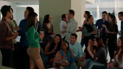 people socializing and drinking at an indoor party