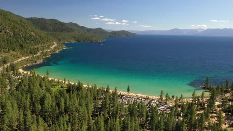 Serene-View-Of-Lake-Tahoe-Surrounded-With-Forest-Mountains-In-California