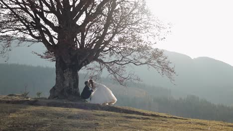 Newlyweds.-Caucasian-groom-with-bride-on-mountain-slope.-Wedding-couple.-Happy