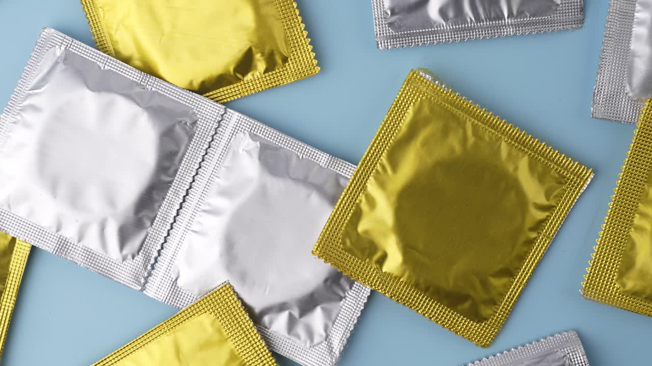 Showing packets of condoms on a blue background