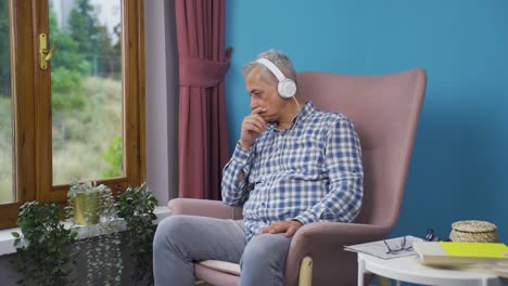 Unhappy-man-listening-to-music-with-headphones.