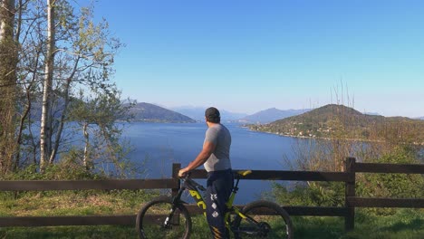 fpv view toward man with hat looking at lake maggiore panorama