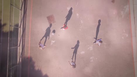 Animation-of-light-spots-over-diverse-schoolchildren-playing-football