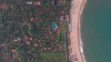 goa sinquerim beach drone shot shack view from the beach to waves top birds-eye view extreme top cinematic villa hotel by the beach