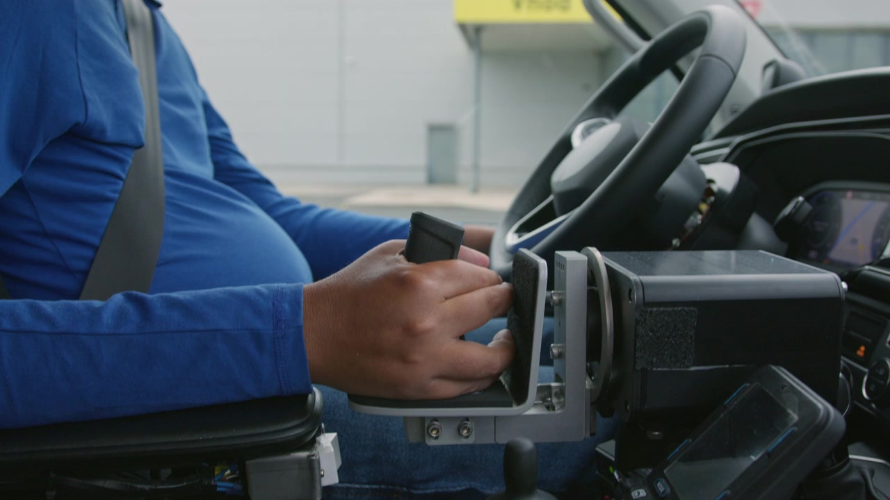 Adaptive driving hand controls and dashboard inside an accessible vehicle used by a person with