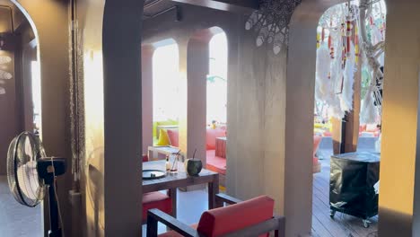 a serene beachside lounge with colorful seating and ambient lighting, capturing a tranquil atmosphere in phuket, thailand