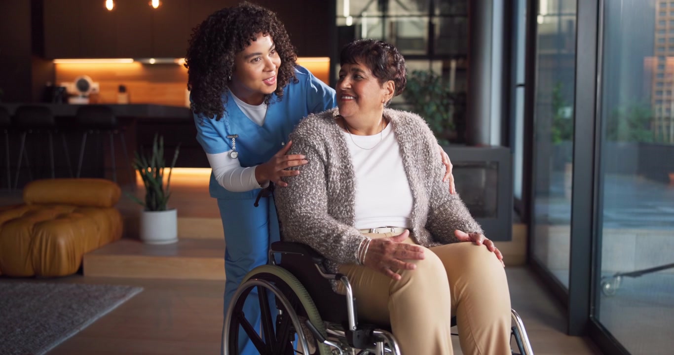 Caregiver Comforting Senior Woman in Wheelchair at Home