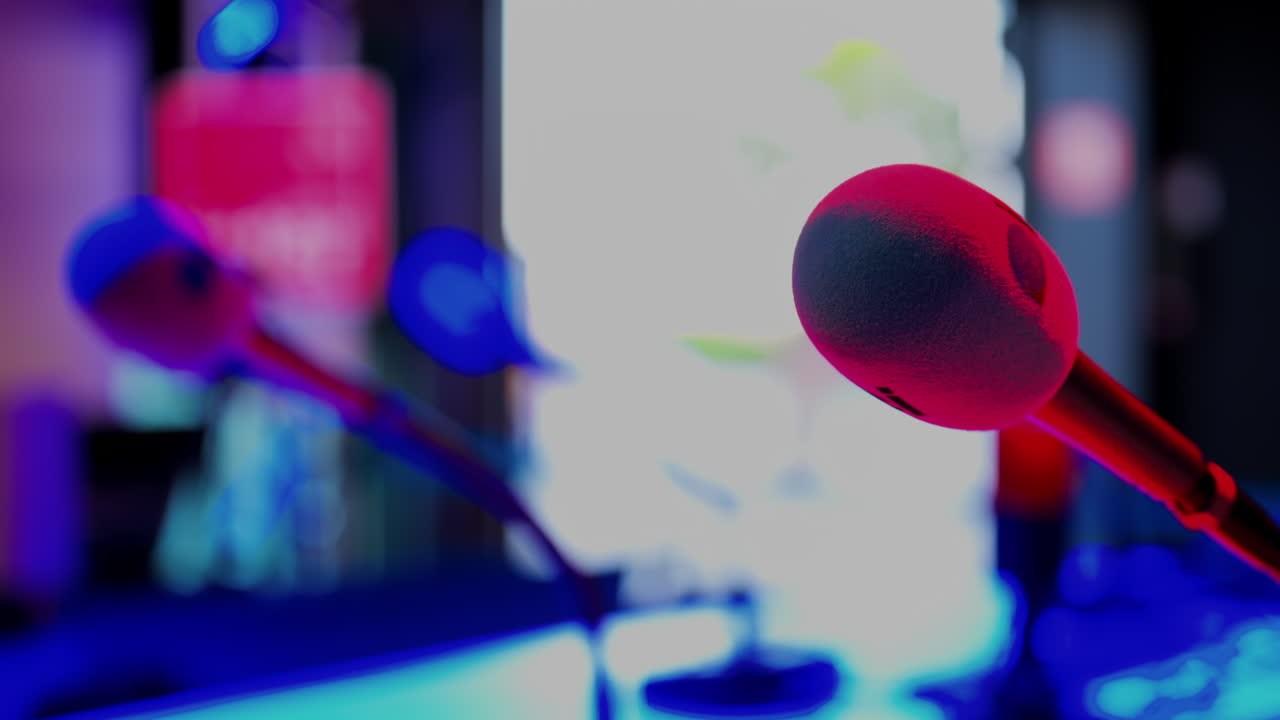 Close up of a microphone on a blurred background with blue and red lights at the International Games Festival in Cannes, France