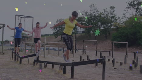 women balancing on outdoor obstacle course with colorful star animation overlay