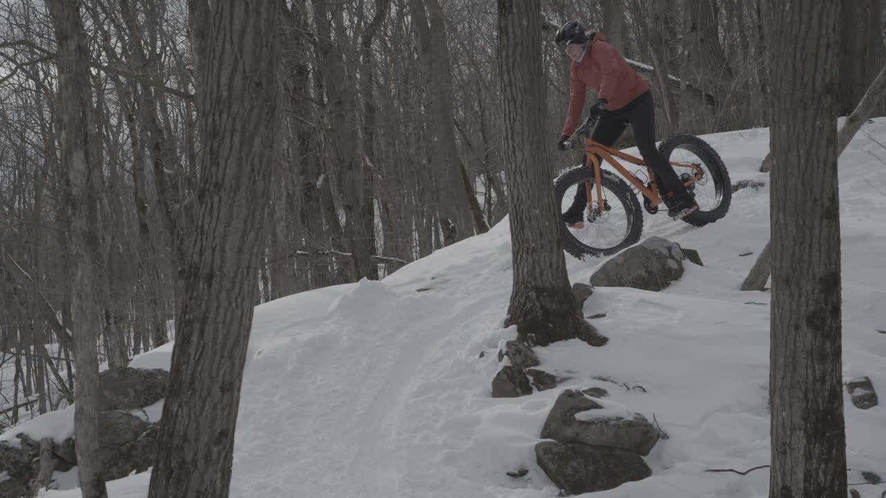 Slow motion fatbike crash on a snow covered path