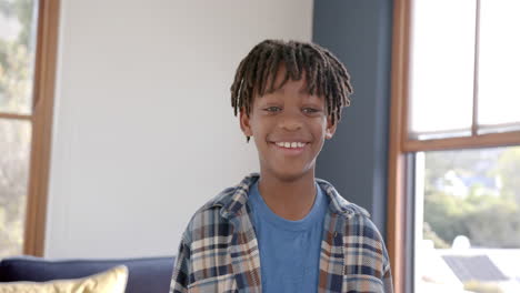 portrait of happy african american boy at home, slow motion